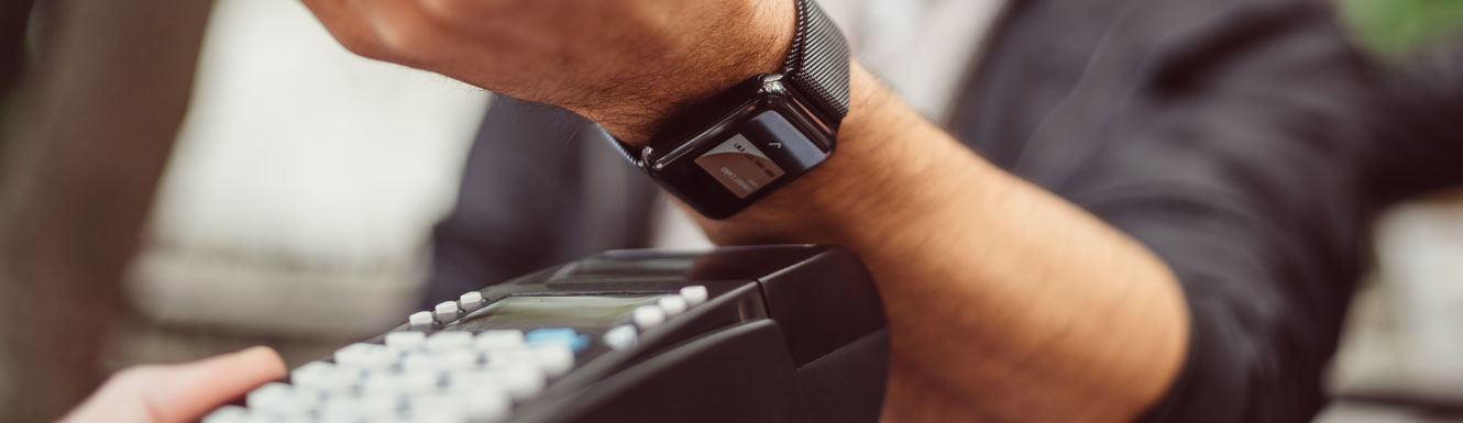 A man is using Mobile Wallet with his smartwatch to make a purchase.