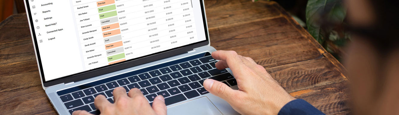 A mockup of the Autobooks product on a laptop, with a man's hands on the keyboard.