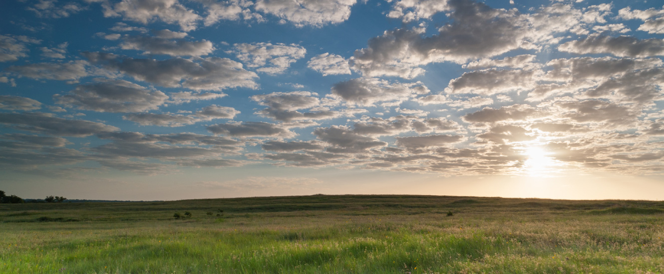 landscape with rolling hills and cloudy skies